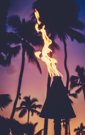 Hawaii Tiki Torches During A Beautiful Tropical Sunsetの写真素材