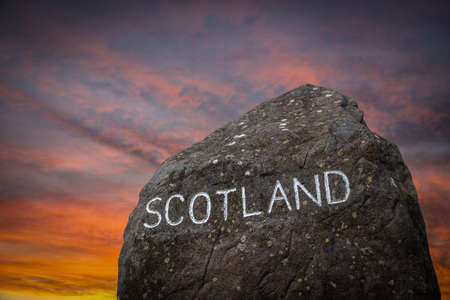 A Stone Marking The Border Between England And Scotland During A Beautiful Sunsetの写真素材
