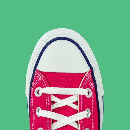 Retro Vintage Red Canvas Basketball Boots From Above On A Green Backgroundの写真素材