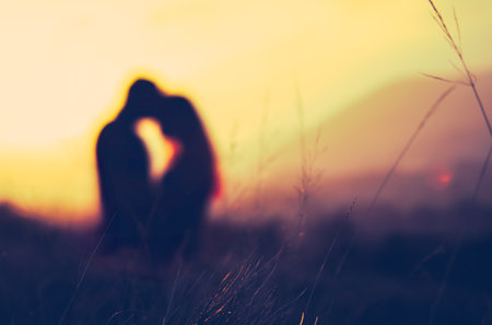 Retro Filtered Image Of A Romantic Couple Embracing Fitness At Sunsetの写真素材