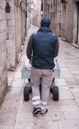 A Delivery Man At Work In The Narrow Streets Of Dubrovnik, Croatiaの写真素材