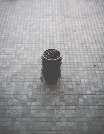 Abstract Image Of A Round Vent Or Grease Pipe Protruding From A Tiled Wall Surfaceの写真素材