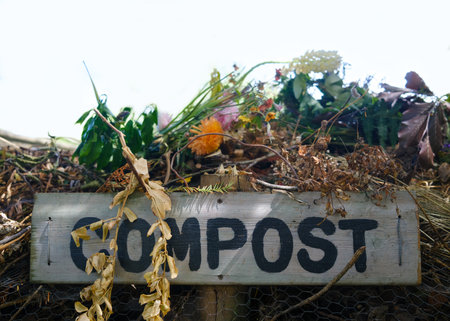 Rustic Wooden Compost Sign On A Heap Of Garden Waste And Dead Flowers