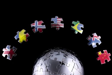 Jigsaw flags around a chrome globeの写真素材