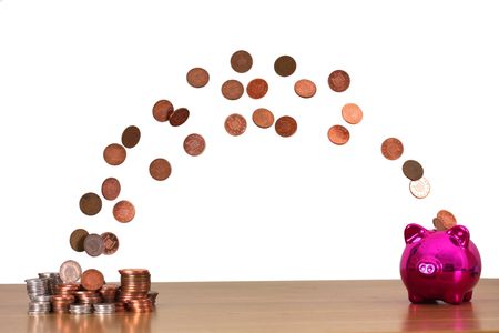 Pink Piggy bank with money transferring to itの写真素材