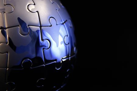 Globe jigsaw completed with blue tintの写真素材