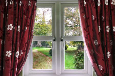 Window and curtains with view of a English church gardenの写真素材