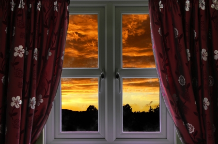 Window with a view to a fiery skyの写真素材