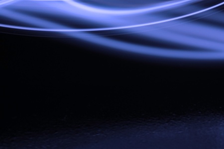 Blue swish on a black background and reflectionの写真素材