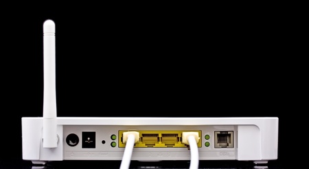 Wireless router with cables flying out, on blackの写真素材