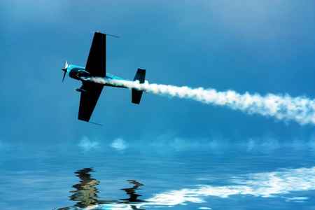 Stunt plane flying close to waterの写真素材