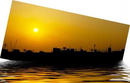 Artistic ship silhouette with orange sunsetの写真素材