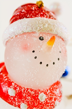 Happy snowman smiling with snow and Christmas hatの写真素材