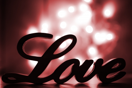 Love sign with red sparkle lights behindの写真素材