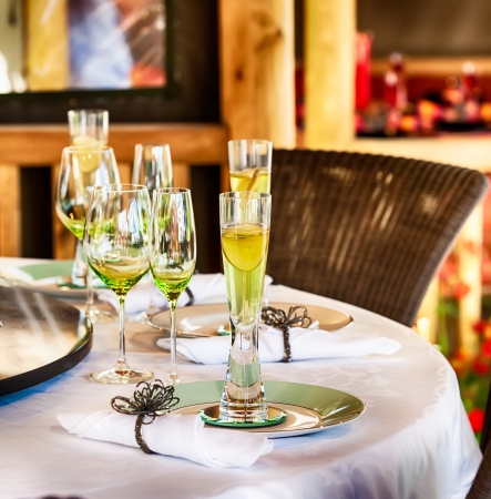 Dining table set for a party with glasses and tableclothの写真素材
