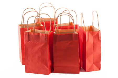 Group of red shopping bags on a white backgroundの写真素材