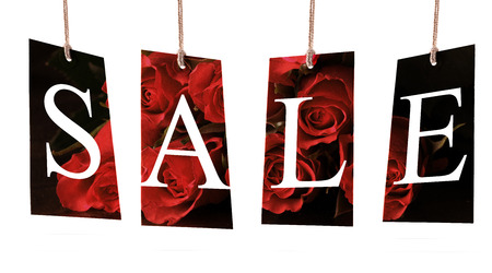 Labels with letters spelling sale on rose card and white backgroundの写真素材