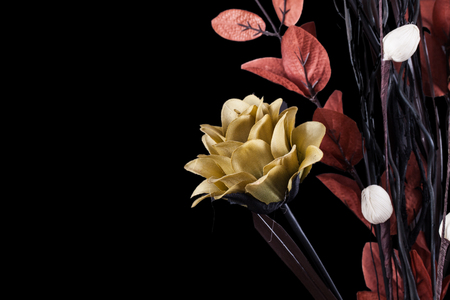Flower arrangement with warm dark tones on a black background landscape orientationの写真素材