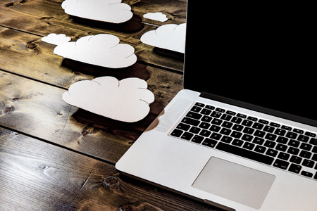 Cloud computing concept laptop close up with white clouds coming out of the computer indicating...