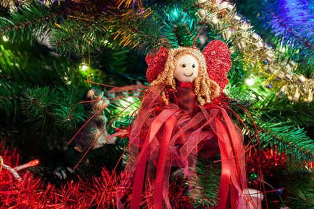 Cute Christmas tree red angel on a decorated Christmas treeの写真素材
