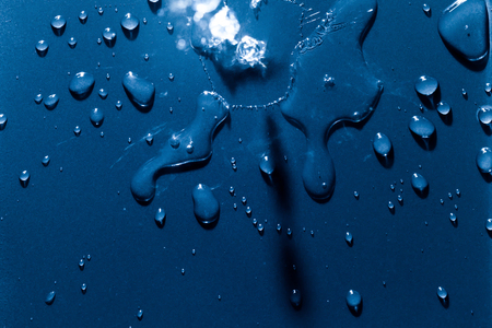 Beautiful water splashes viewed from above on a blue backgroundの写真素材