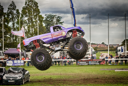 NORFOLK, UK - AUGUST 19th, 2017: Truckfest Norwich is a transport festival. Monster Truck big air jump over crushed carsのeditorial素材