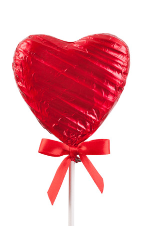 Red Chocolate love heart lollypop with a red ribbon bow on a stick. Isolated on a white backgroundの写真素材