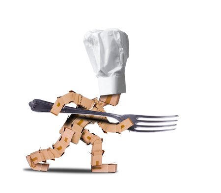 Chef box character holding a large fork like a spear. White hat and white background. Cooking, job and food concept.の写真素材