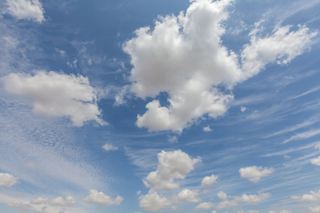 Beautiful white clouds and blue sky background over England UK. Fluffy and wispy cloudscape backdropの写真素材
