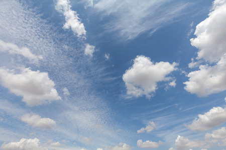 Beautiful white clouds and blue sky background over England UK. Fluffy and wispy cloudscape backdropの写真素材