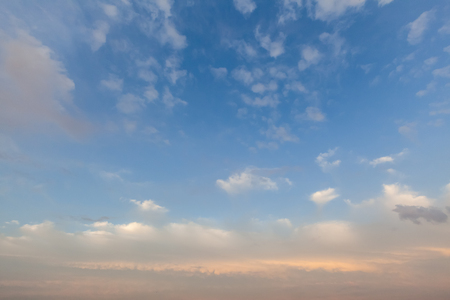 Soft pink cloudscape at sunset in the UK over Norfolk. Blue sky  and white fluffy cloudsの写真素材