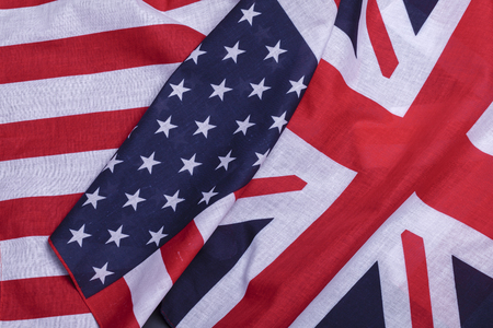 Two flags English union jack and USA star spangled banner. Material symbols of first world countriesの写真素材