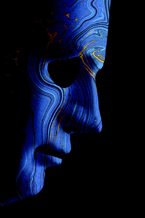 Robot blue face mask side view close up with contoured textured skin and blank eyes. Black background and space for text. Artificial intelligence concept in a human formの写真素材