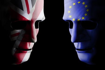 Brexit UK EU concept with face masks for each side and country flag texture on face. Black background.の写真素材