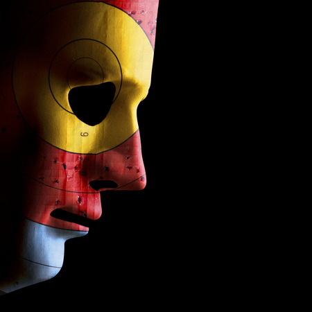 Side view of a scary halloween face mask with a used archery target as skin. Concept of target skin conditions. Black copy space.  の写真素材