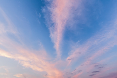 Pink cloud lines and blue sky at sunset. Cloudscape view of natural sky patternの写真素材