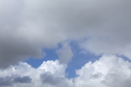 Weather clouds in blue sky. white and grey rain clouds with clear sky behindの写真素材