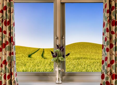 Rural scene from a country house looking onto rolling hills of crops and blue skies.の写真素材