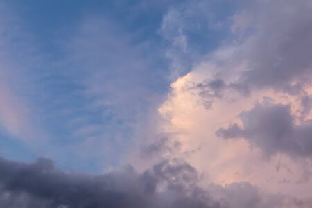 Beautiful pink clouds in the blue sky during sunset dusk hours. Natural cloudscape background pattern の写真素材