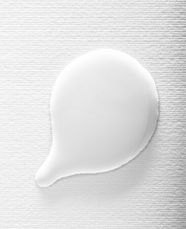 White paint textured bubble on a white background. Abstract wet liquid speech bubble shapeの写真素材