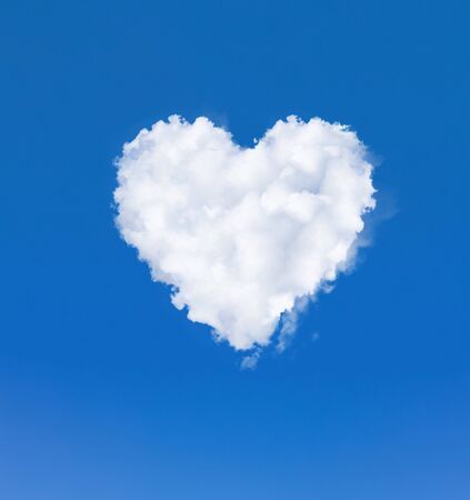 Heart shape cloud in the sky. One white cloud in a blue sky. Romantic love and health symbolの写真素材