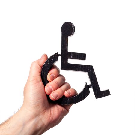 Disabled symbol being held up my a human hand. Power to disabled people sign on a white backgroundの写真素材