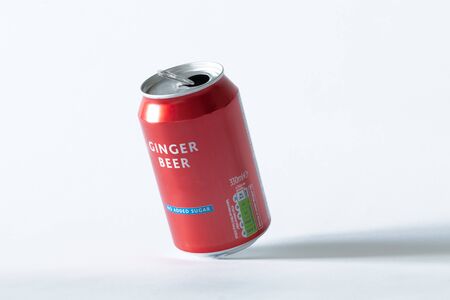 An opened can of ginger beer on a white isolated background. Drink and recycling concept.の写真素材