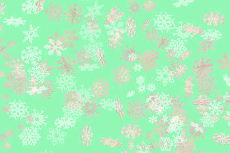 Beautiful snowflake pattern white and gold falling on a subtle pastel green backgroundの写真素材