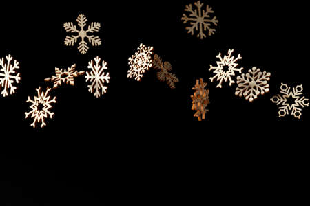 Snowflake pattern with falling snowflakes and space for text on a black backgroundの写真素材