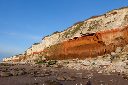 Hunstanton cliffs in North Norfolk viewed from the beach. March 2017. These eroding cliffs expose a mid-Cretaceous sequence from the Albian to the succeeding Cenomanian around 100 million years ago, with exceptionally rich Albian ammonite fossilsの写真素材