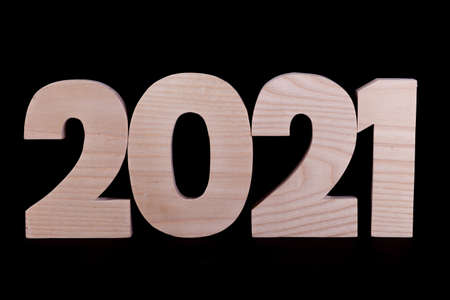 2021 year large wooden numbers squashed together. Hardwood characters on a black backgroundの写真素材