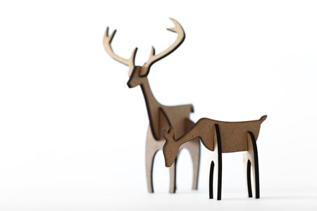 Reindeer stag and young deer cardboard toy isolated on a white background. Christmas icon and shapes with text spaceの写真素材