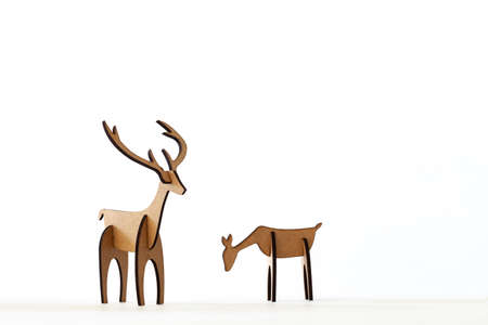 Reindeer stag and young deer cardboard toy isolated on a white background. Christmas icon and shapes with text spaceの写真素材
