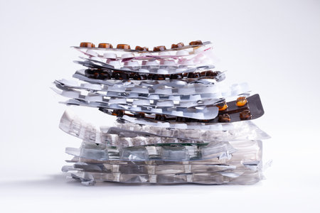 Stack of empty pills and tablet packets isolated on a white backgroundの写真素材